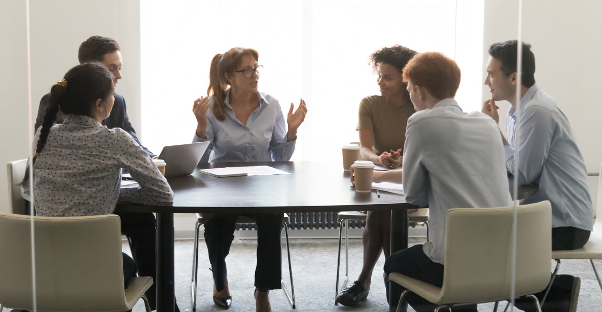 Picture. A manager leading a group meeting.