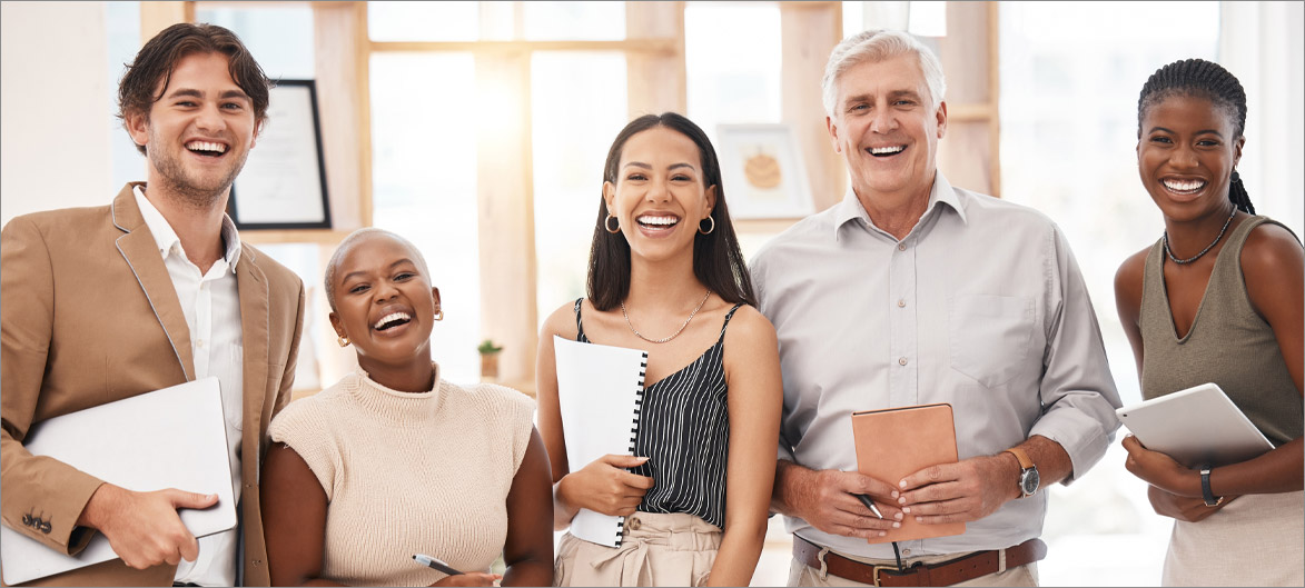 Picture. A group of employees smiling.